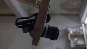 camera with an old manual lens in a wooden pendant construction ready for shooting. 4k. 4k video. 60 fps