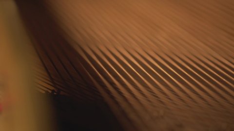 close up detail of piano strings and hammers , abstract music video artistic footage music instrument