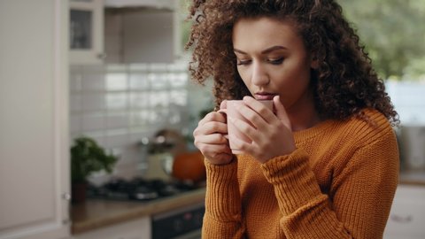 Young woman drinking hot tea in autumn time 