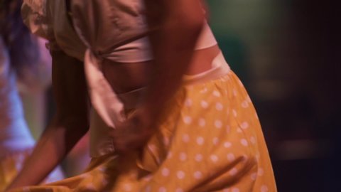 girls dancers dancing joyfully with yellow skirts at Cuba, exotic dancers close up