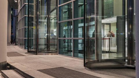  The flow of people passing through the revolving door of the modern office building at the end of the working day,time lapse