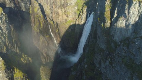 voringfossen waterfall in norway with rainbow at 2