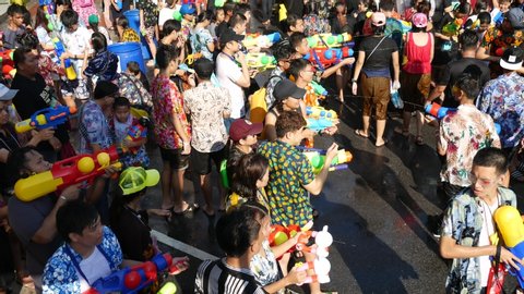 Bangkok, Thailand-April 14, 2018: Locals and tourists celebrate Songkran Festival, Traditional Thai New Year. People play water, and use water guns to enjoy the festival.