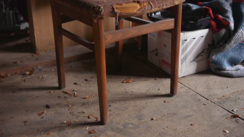 Panorama of an old wooden chair with torn upholstery in the attic