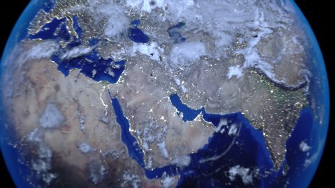 Zoom out of Kuwait through clouds to see the Earth from space.