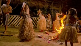 indigenous performing dance around the fire traditional event in amazonian jungle at night in ecuador