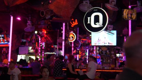 Phuket / Thailand - 06 01 2018: Night club and bar with neon lights at tourist area in Phuket, Slow motion pan