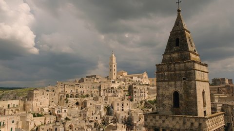 Historic old center of Matera, Basilicata, Italy - European capital of culture. Time lapse shot. Dramatic fast moving clouds.