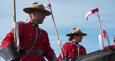 Hay River , Northwest Territories / Canada - 08 25 2019: Male and female officers of the Royal Canadian Mounted Police on horseback