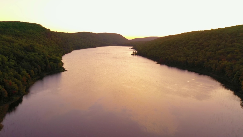 Pullback to reveal massive Lake of the Clouds in Porcupine Mountains State Park during Sunrise