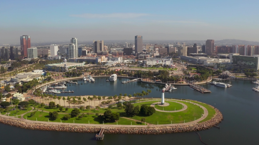 Beautiful aerial view around mothers beach at Long Beach in Los Angeles, USA. Flying over the yachts near Queen Mary ship and Long Beach lighthouse.