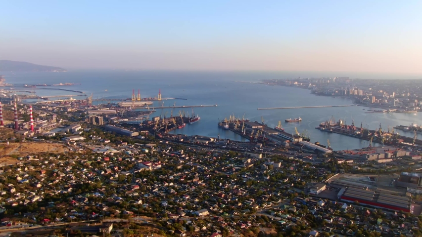 Aerial view of port city. Camera moving forfard, twilight.