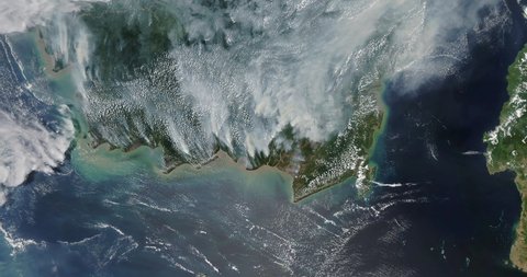 Very high-altitude overflight aerial of fires raging across South Kalimantan, Indonesia. Clip loops and is reversible. Elements of this image furnished by NASA