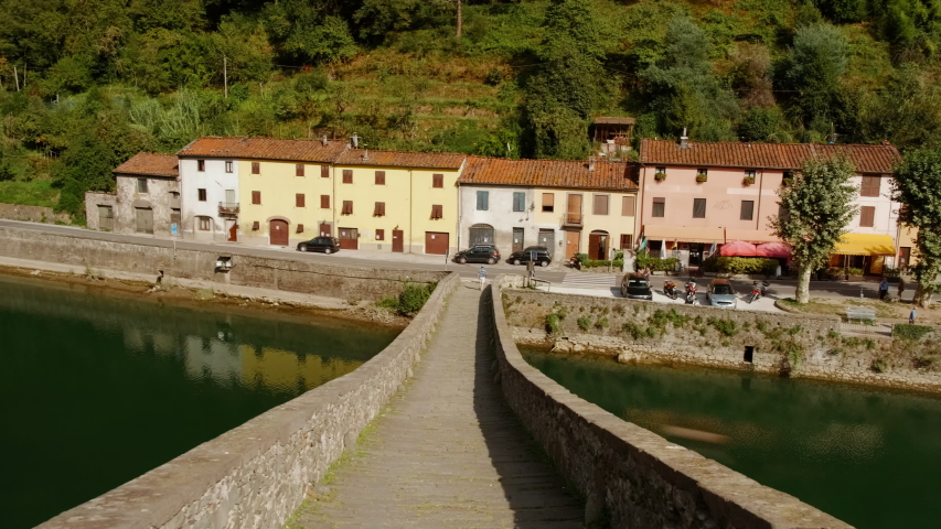 Walking the Ponte del Diavolo, also known as Ponte della Maddalena, a bridge crossing the Serchio river, Borgo a Mozzano, Tuscany, Italy