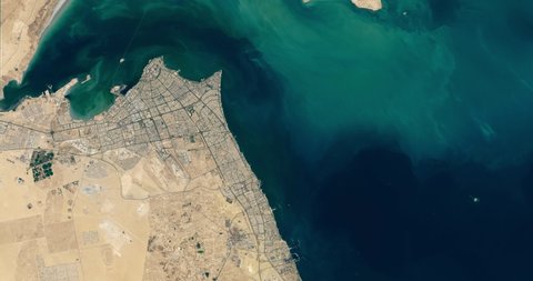 Very high-altitude overflight aerial of Kuwait City, Kuwait Bay and the Persian Gulf. Clip loops and is reversible. Elements of this image furnished by NASA