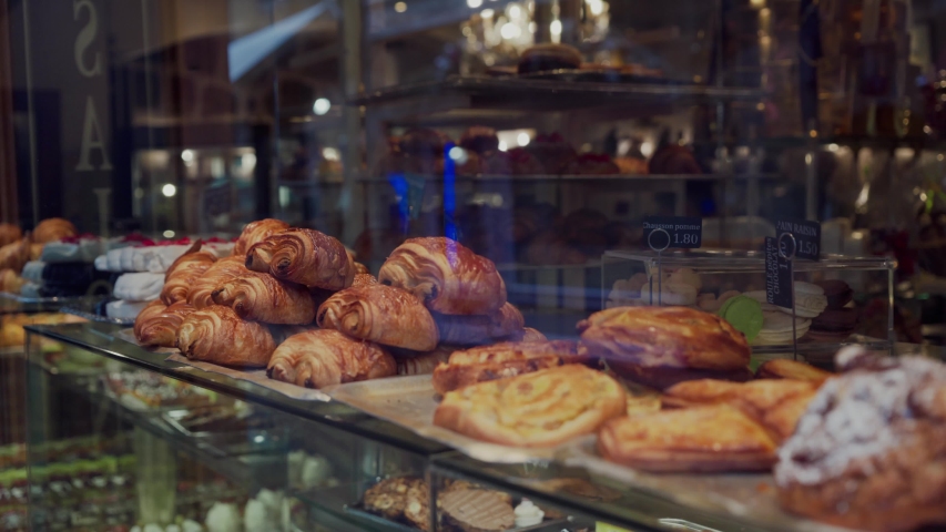 Freshly baked croissants and various gourmet bake for sale in Parisian bakery. Close up. Traditional French Cuisine | Shutterstock HD Video #1038017174