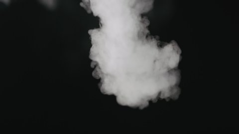 Slow motion water mist puff stream over black background