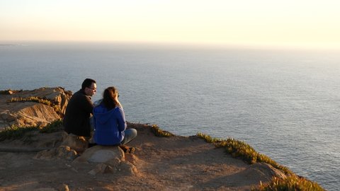 Cabo da Roca, Potugal - December 27, 2017: Couple in love looking at the ocean.