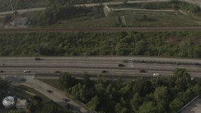 Aerial view of vehicles on a Malaysian highway in the morning. Panning to the left.