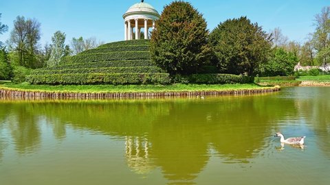 Parco Querini is green area of city of Vicenza, Italy. Monopteros is circular colonnade supporting roof but without any walls. Unlike tholos, it does not have walls making cella or room inside.