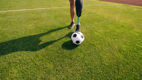 A football is being dribbled by a man with a prosthetic leg - Powered by Shutterstock - Get 15% off with code: PIKWIZARD15