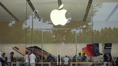 AIX EN PROVENCE, FRANCE - CIRCA July 2019: Close up of transparent Apple store front in France with famous logo. People shopping inside