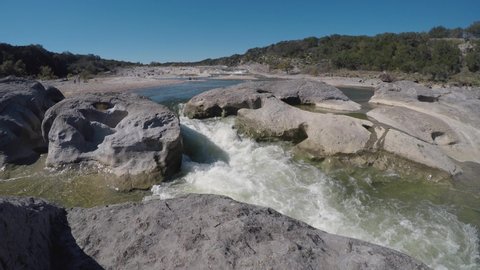 Water rushes through the rocks into shallow pools at Pedernales Falls State Park
