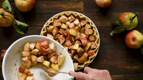 Cooking process of apple pie. Pastry dough with apple pie filling on a wooden table background, top view. Autumn comfort food