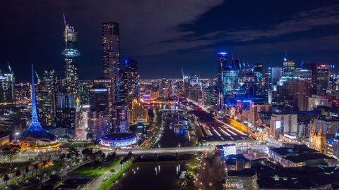 Aerial hyperlapse of night Melbourne CBD at Flinders Street in Melbourne along with Yarra River, Australia
