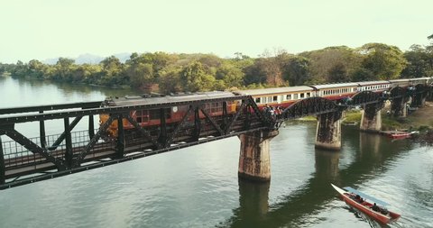 Kwai River at Kanchanaburi aerial of Bridge New Years Eve and Day including Train, boats and Tourists.