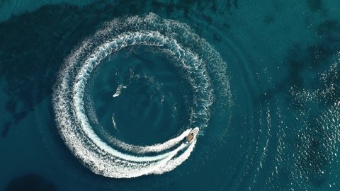 Aerial shot of speedboat riding in a circle in the sea. Top travel destination. 4K. Croatia