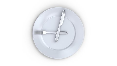 Healthy lifestyle concept. a plate with a clock. it's time to eat. White plate with knife and fork as a watch hand view from above