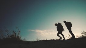 teamwork happy family business travel silhouette slow motion video concept. happy family slow motion video walking on nature. girl and man couple in a field on trekking trip. tourists with backpacks