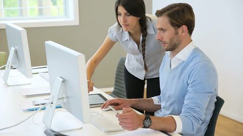 Business people working in office on desktop computer