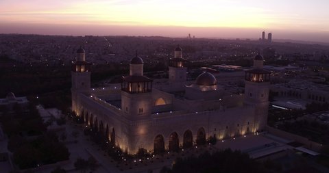 AMMAN, JORDAN - CIRCA 2019 - beautiful rising aerial shot at dusk of the Islamic mosque in downtown Amman, Jordan.