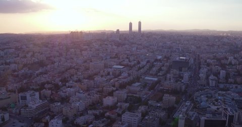 AMMAN, JORDAN - CIRCA 2019 - aerial over the city of Amman, Jordan downtown business district, skyscrapers and offices at sunset.