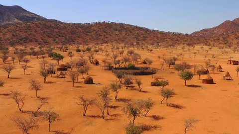 NAMIBIA - CIRCA 2018 - Low aerial over a Himba African tribal settlement and family compound in northern Namibia, Africa.