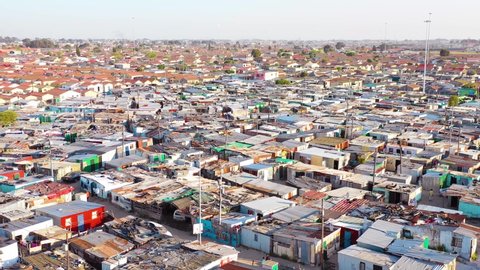 GUGULETHU, SOUTH AFRICA - CIRCA 2018 - Aerial over contrasting townships of South Africa, with poverty stricken slums, streets and ghetto buildings.