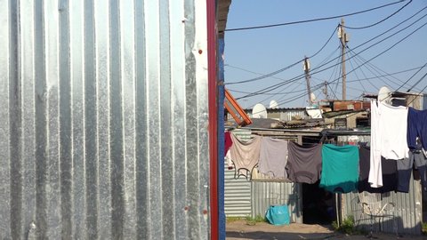 GUGULETHU, SOUTH AFRICA - CIRCA 2018 - Establishing shots of a typical township in South Africa, Gugulethu, with tin huts and poverty.