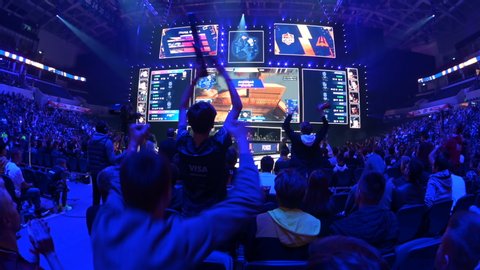 MOSCOW, RUSSIA - 14th SEPTEMBER 2019: esports Counter-Strike: Global Offensive event. Happy dedicated fans at arena. Cheering with a hands raised.
