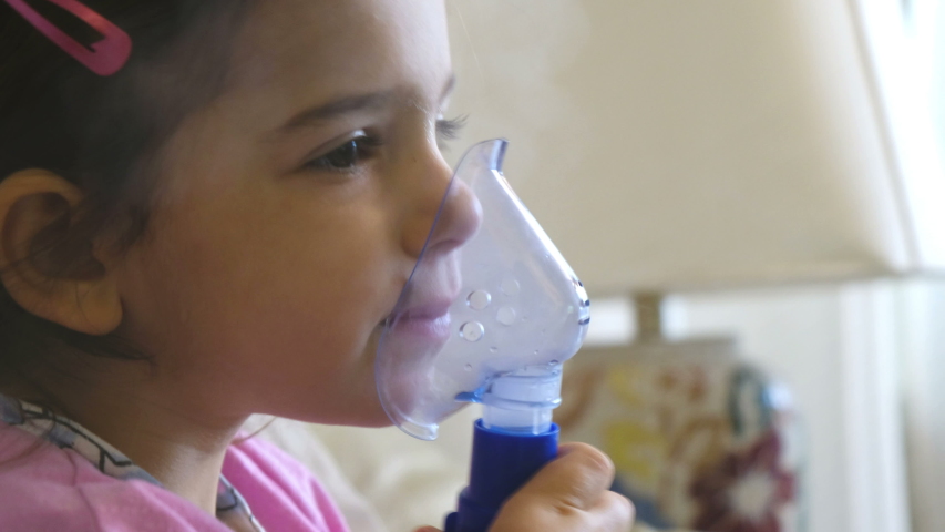 Childhood asthma inhaling mask illnesses little baby girl with flu id doing aerosol independently . | Shutterstock HD Video #1038103385