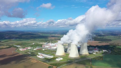 Aerial view to nuclear power plant. Atomic power stations are very important sources of electricity with low carbon footprint. Industrial emissions and ecology in 21th century.