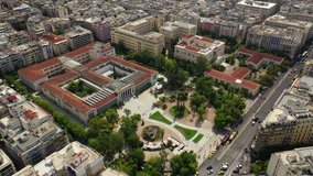 Aerial drone video of iconic public neoclassic National Technical University of Athens and National Archaeological museum in the heart of Athens, Attica, Greece