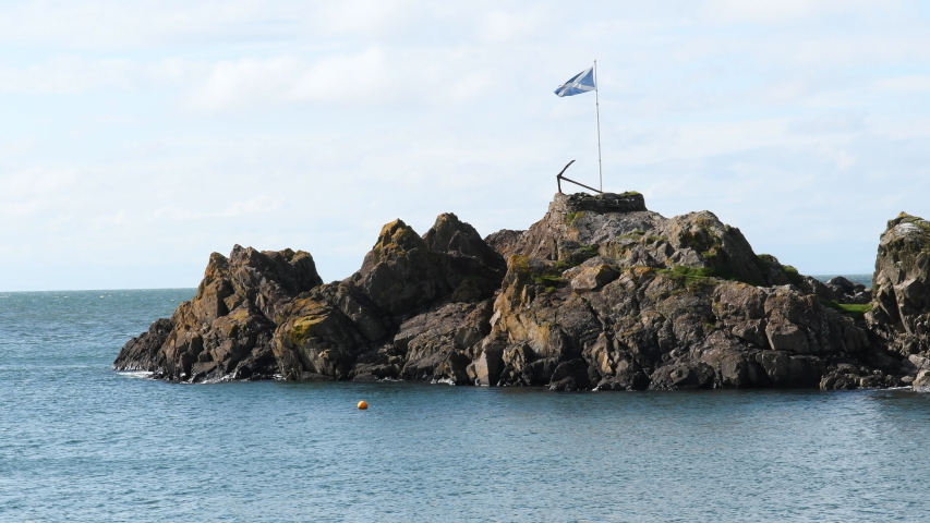 Viewpoint in Portpatrick. Scenic view of ocean and Scottish flag and anchor at Harbour of Portpatrick in Dumfries and Galloway in Scotland. Sunny day in autumn in the south west of Scotland. 