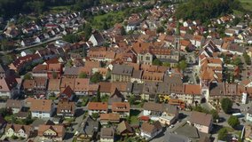 Aerial view of the village Bräunlingen in Germany in the black forest on a sunny day in summer. Pan to the right around the old town.