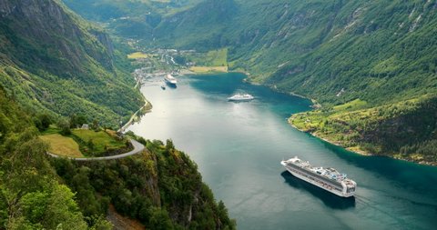 Geirangerfjord, Norway. Touristic Ship Ferry Boat Cruise Ship Liner Floating Near Geiranger In Geirangerfjorden In Sunny Summer Day. Famous Norwegian Landmark And Popular Destination. Panorama