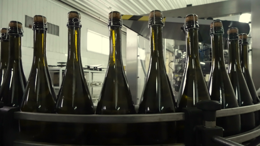 Bottling and sealing conveyor line at winery factory | Shutterstock HD Video #1038164519
