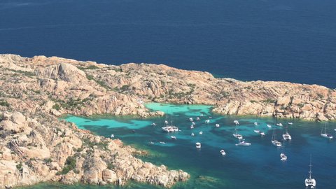 View from above, stunning aerial view of Cala Coticcio also known as Tahiti with boats and yachts floating on a turquoise clear water. La Maddalena Archipelago, Sardinia, Italy.