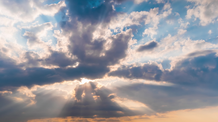 Timelapse: sun beams shining through moving dramatic white clouds. Cloudy blue sky, warm sunrise or sunset illumination, sun lens flare. Time lapse, peaceful, hope, religion, spiritual, nature concept Royalty-Free Stock Footage #1038184466