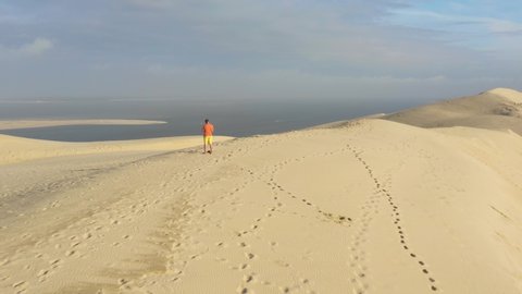 France, man alone on the top of Dune du Pilat, drone aerial view